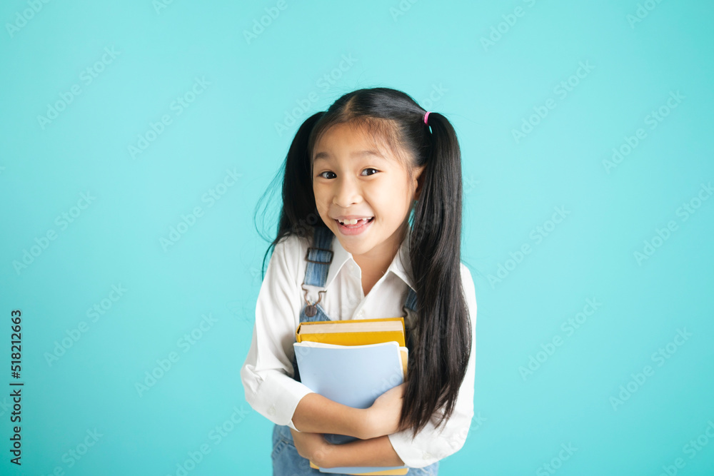Close-up kid students girl smiling holding book, going to school. Close-up kid students girl smiling holding book, going to school.
