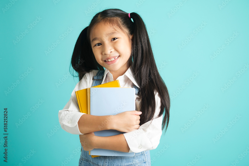 Close-up kid students girl smiling holding book, going to school. Close-up kid students girl smiling holding book, going to school.