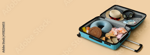 Open suitcase with tourist'...