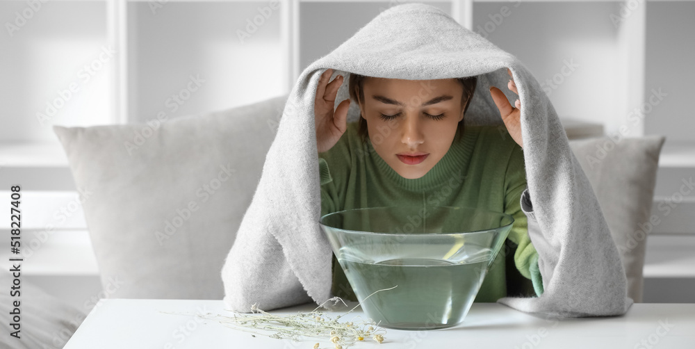 Young woman doing steam inhalation at home to soothe and open nasal passages - obrazy, fototapety, plakaty 