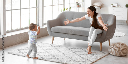 Mother teaching her cute ba...
