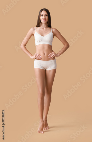 Young tanned woman in under...