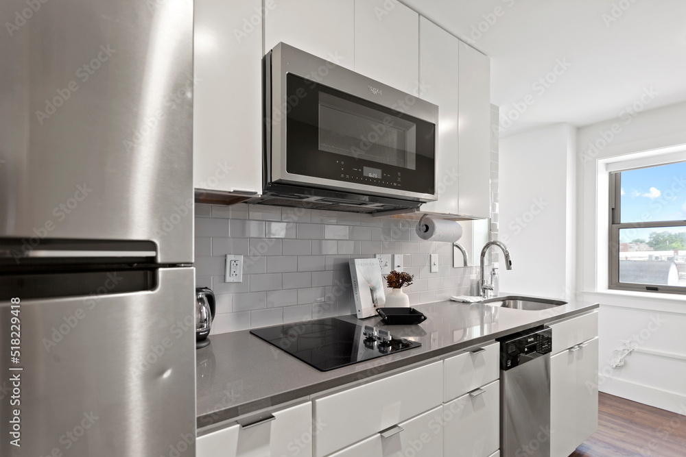Modern Efficiency: Short-Term Rental with White Cabinets, Wood Floors, and Open Floor Plan Modern Efficiency: Short-Term Rental with White Cabinets, Wood Floors, and Open Floor Plan