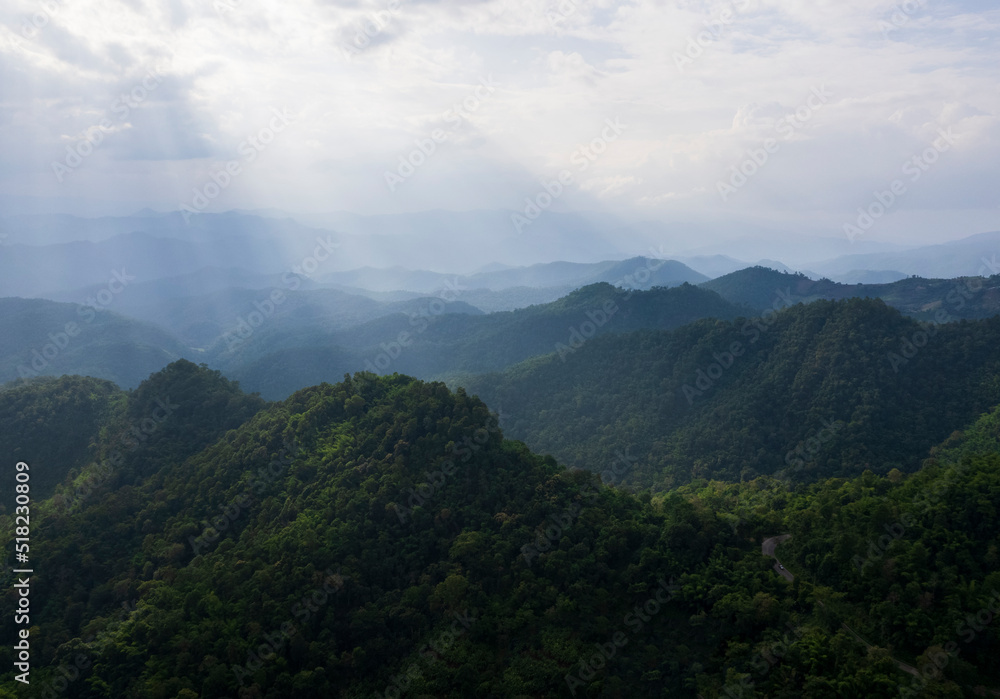 Top view Landscape of Morning Mist with Mountain Layer at north of Thailand. mountain ridge and clouds in rural jungle bush forest Top view Landscape of Morning Mist with Mountain Layer at north of Thailand. mountain ridge and clouds in rural jungle bush forest