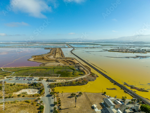 Aerial panorama view of Alviso district in San Jose California with rundown buildings colorful orange, yellow salt marshes in the Bay Area photo