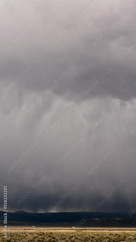 Timelapse of thick clouds raining over the plains in Wyoming during Spring moving through the landscape. Timelapse of thick clouds raining over the plains in Wyoming during Spring moving through the landscape.