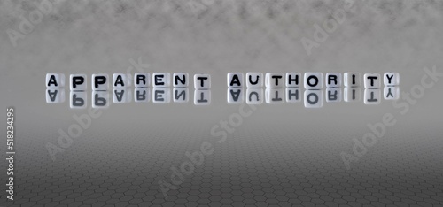 Fotografie apparent authority word or concept represented by black and white letter cubes o