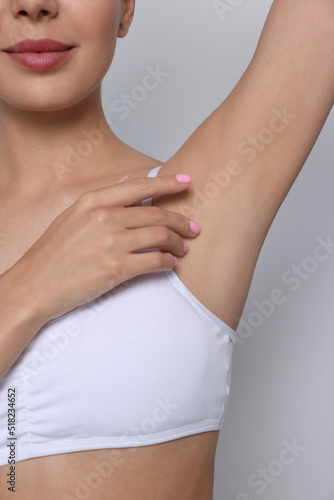 Wallpaper Mural Young woman showing smooth skin after epilation on white background, closeup Torontodigital.ca