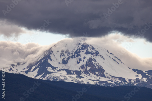 Snow covered mountain with heavy grey clouds © Shane Cotee