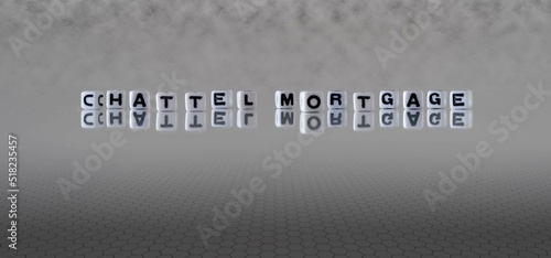 chattel mortgage word or concept represented by black and white letter cubes on a grey horizon background stretching to infinity