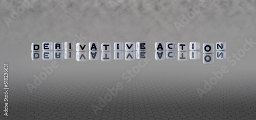 derivative action word or concept represented by black and white letter cubes on a grey horizon background stretching to infinity photo