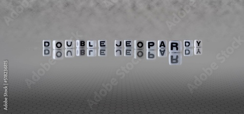 double jeopardy word or concept represented by black and white letter cubes on a grey horizon background stretching to infinity