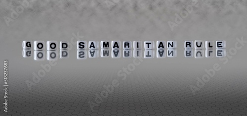 good samaritan rule word or concept represented by black and white letter cubes on a grey horizon background stretching to infinity photo