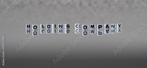Billede på lærred holding company word or concept represented by black and white letter cubes on a