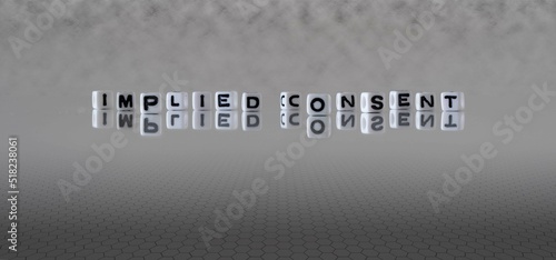 Принти на полотні implied consent word or concept represented by black and white letter cubes on a