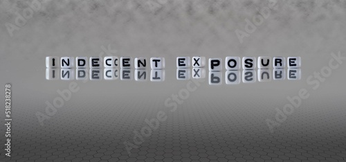 Foto indecent exposure word or concept represented by black and white letter cubes on