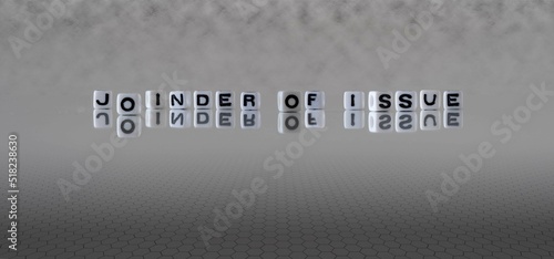 joinder of issue word or concept represented by black and white letter cubes on a grey horizon background stretching to infinity photo