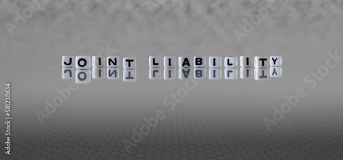joint liability word or concept represented by black and white letter cubes on a grey horizon background stretching to infinity