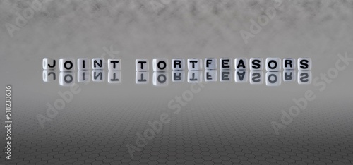 joint tortfeasors word or concept represented by black and white letter cubes on a grey horizon background stretching to infinity