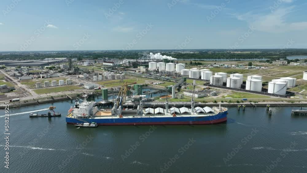 Bulk Carrier Ship at Port Offloading Cargo and Commodities Bulk Carrier Ship at Port Offloading Cargo and Commodities