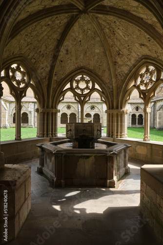 Monastery of Santa María la Real de Iranzu, interior courtyard with a central fountain surrounded by arches carved in stone, Navarra, Spain. © jordi