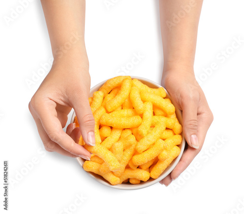 Fotografie Woman holding bowl of crunchy cheesy corn sticks on white background, top view