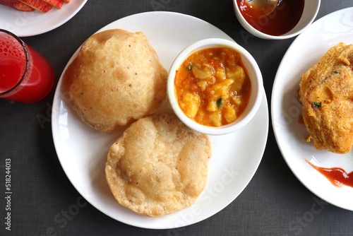 Indian cuisine - Puri Bhaji. It is a traditional breakfast dish in North India. Puri is a deep fried bread made from whole wheat flour and Served with spicy Potato curry called bhaji or alu ki sabzi.