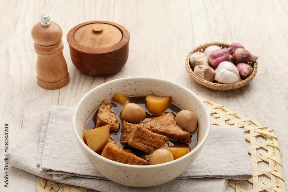 Fototapeta premium Semur, Indonesian traditional food, with tofu, quail eggs and potatoes, served in a bowl