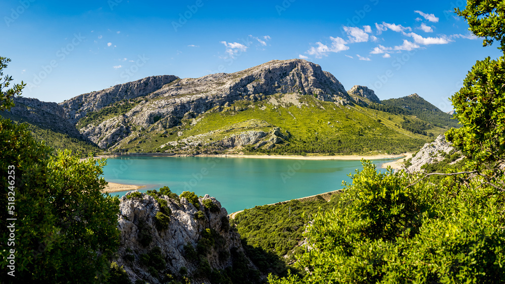 High angle view panorama of Palma de Mallorca drinking water reservoir called Embassament de Cuber with the mountain peaks Puig de Sa Rateta, Puig de Na Franquesa and Puig de L’Ofre in the background.