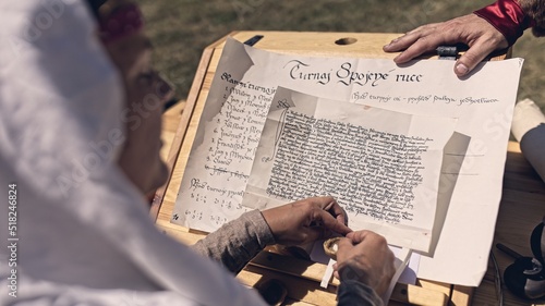 Valokuva Writing important document in 14th century - reenactment event
