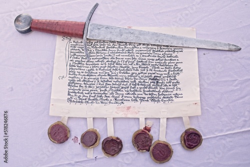 Reenactment important sealed document from event about medieval celebration and wedding daughter rich buyer. Celebration contains prenuptial agreement of parents of bride and groom, of course. photo