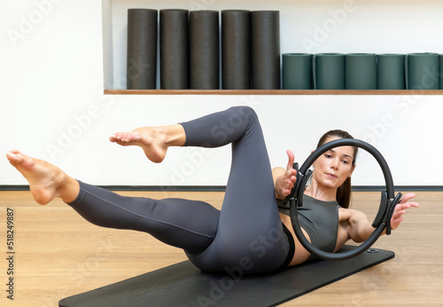 Obraz na płótnie Woman doing exercise with pilates circle in gym