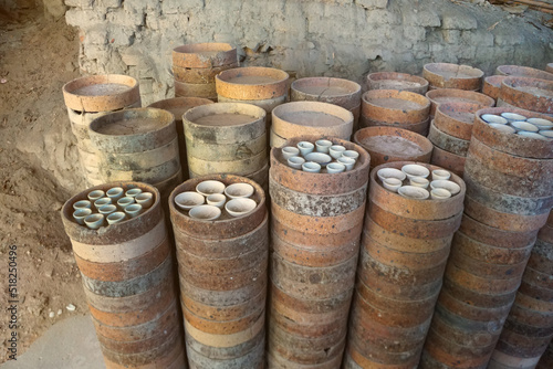 Saggar or Jock is a container of Chicken bowls for protecting flame and ashes from fuel during firing in the kiln. How to make the traditional ceramic pottery. © Montree