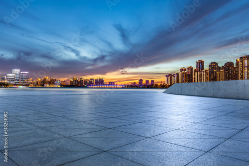 Empty floor and modern city skyline with building scenery at sunset in Suzhou, China.