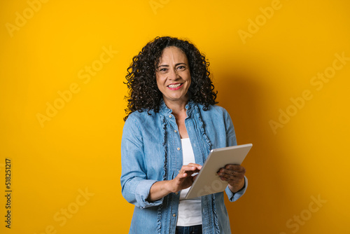 hispanic adult woman portrait on yellow background in Mexico Latin America 