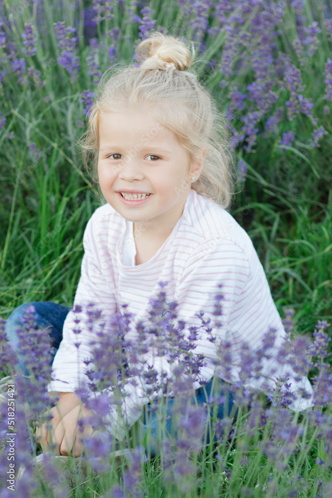 Little beautiful girl with a bouquet of lavender flowers, outdoors Little beautiful girl with a bouquet of lavender flowers, outdoors