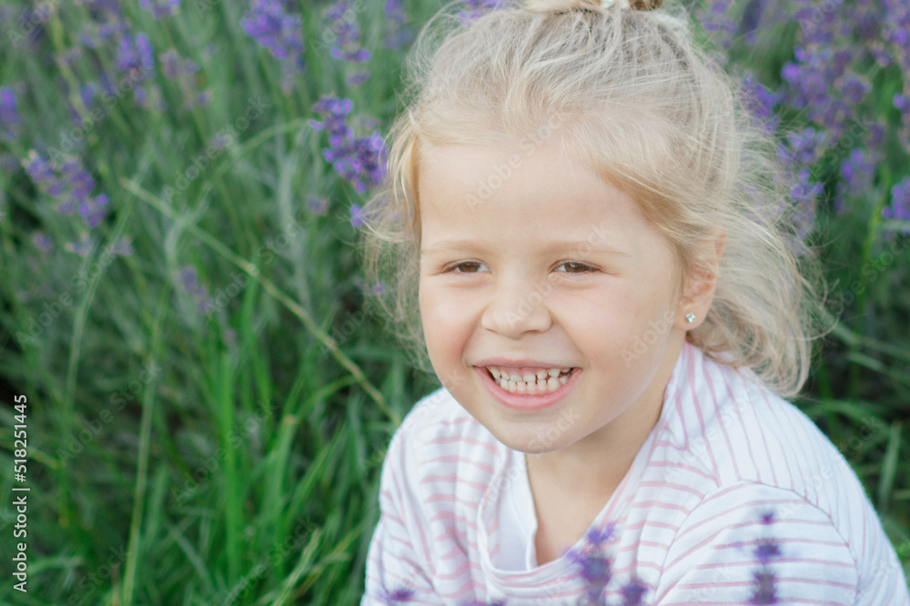 Little beautiful girl with a bouquet of lavender flowers, outdoors Little beautiful girl with a bouquet of lavender flowers, outdoors