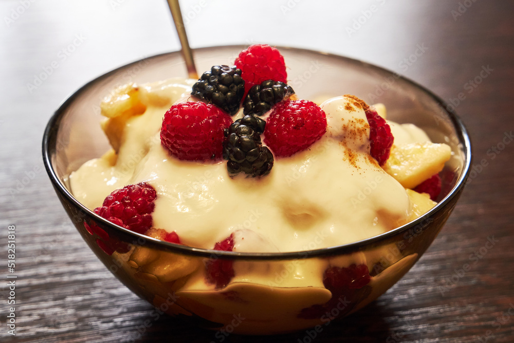 Delicious fruit salad with yogurt. Fresh fruit salad with yogurt in a transparent plate close-up Delicious fruit salad with yogurt. Fresh fruit salad with yogurt in a transparent plate close-up