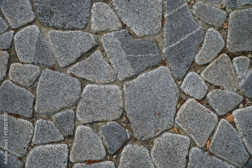 a fragment of a city wall made of natural stone of various textures