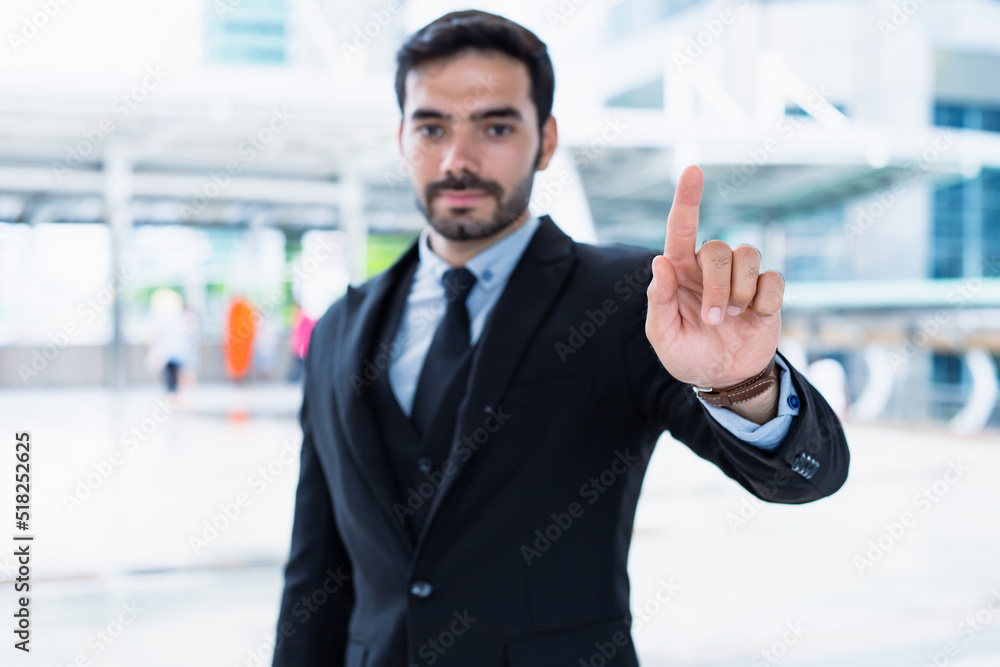 Handsome young businessman in a successful suit present his work reliably. Handsome young businessman in a successful suit present his work reliably.