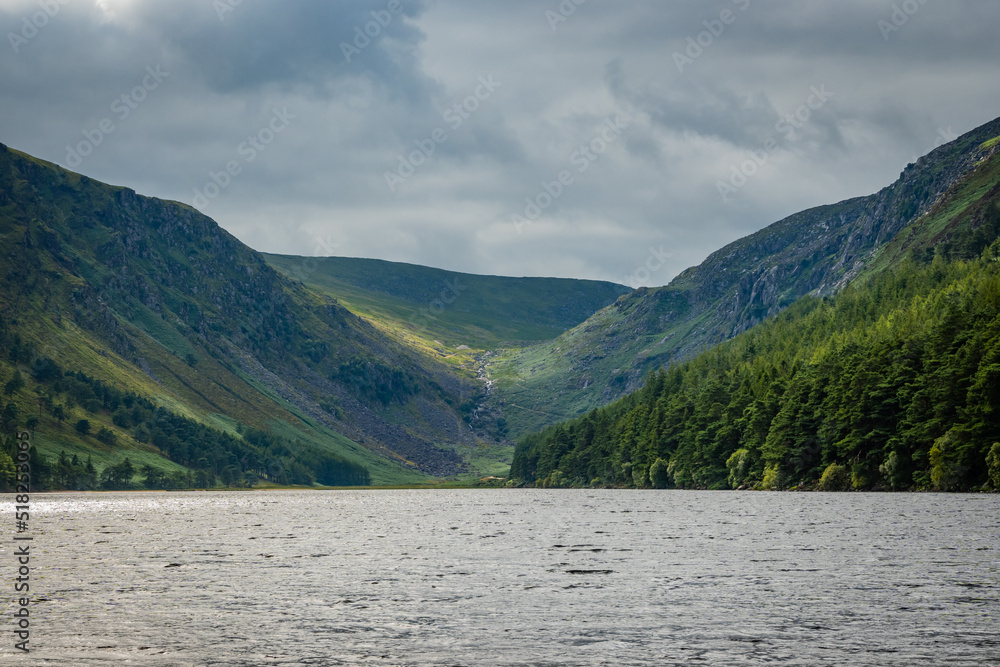 The upper lake in Glendalough. this body of freshwater is in a glacial valley in Co. Wicklow Ireland not far from Dublin and is a popular beauty spot enjoyed by tourists hiking walking sightseeing 