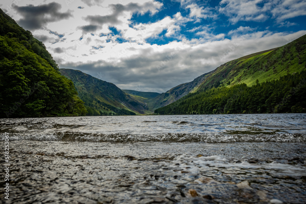 The upper lake in Glendalough. this body of freshwater is in a glacial valley in Co. Wicklow Ireland not far from Dublin and is a popular beauty spot enjoyed by tourists hiking walking sightseeing The upper lake in Glendalough. this body of freshwater is in a glacial valley in Co. Wicklow Ireland not far from Dublin and is a popular beauty spot enjoyed by tourists hiking walking sightseeing