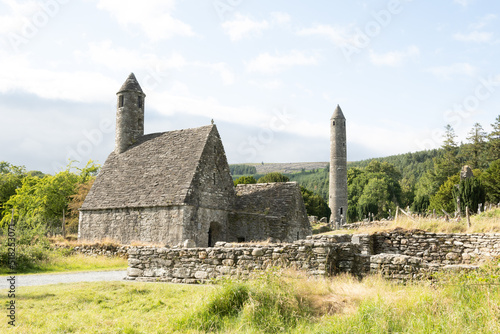 Saint Kevin's church in the Glendalough monastery in Co Wicklow Ireland set in a valley on a sunny day showing perfectly green natural countryside. Irish tourist attraction