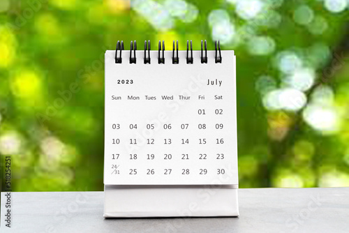 July 2023 desk calendar for planners and reminders on a black table on the natural background.