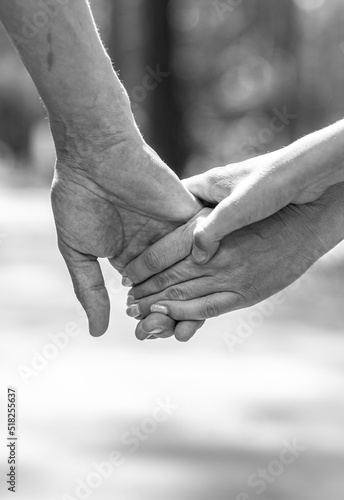 Hands of husband, wife and child close-up. Loving couple and family walking and holding hands. Reliable and strong marriage. The concept of romance, fidelity in marriage and love in the family. 
