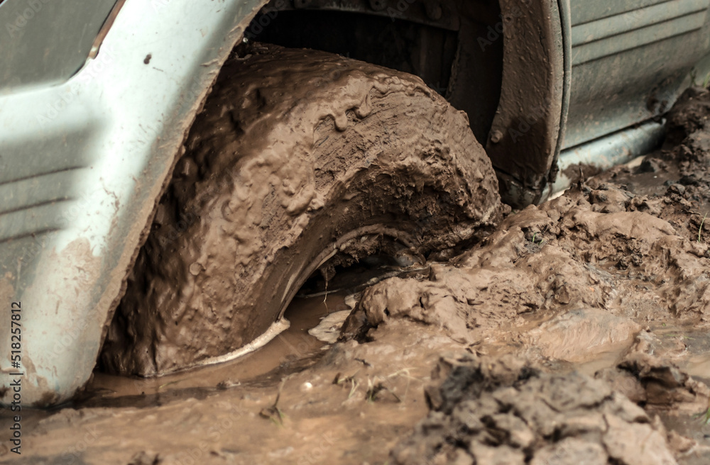 Car wheel stuck in mud, motorsport, mud tire testing. Offroad driving