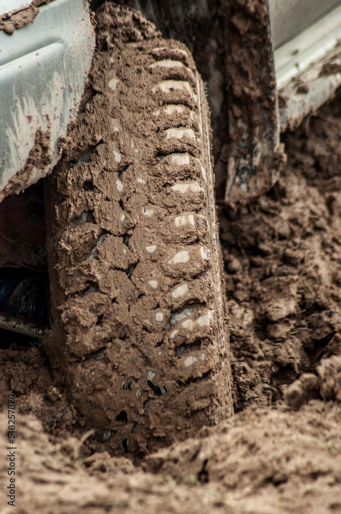 Car wheel stuck in mud, motorsport, mud tire testing. Offroad driving, car breakdown. Emergency
