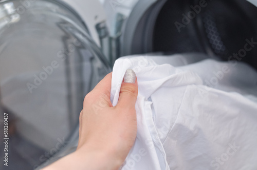 close up of white tidy linen in washing machine,household routine