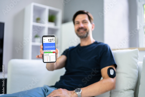 Man Using Continuous Glucose Remote Monitor Diabetes