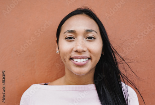 Happy young latin woman looking on camera